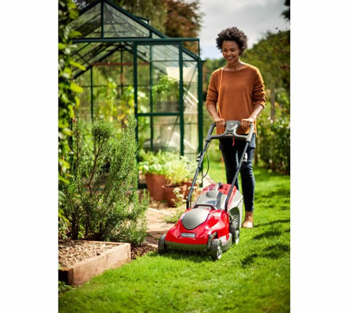 princess34el_lifestyle - Mowers Online Woman mowing lawn with red electric lawnmower