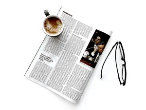 Newspaper with coffee cup and eyeglasses