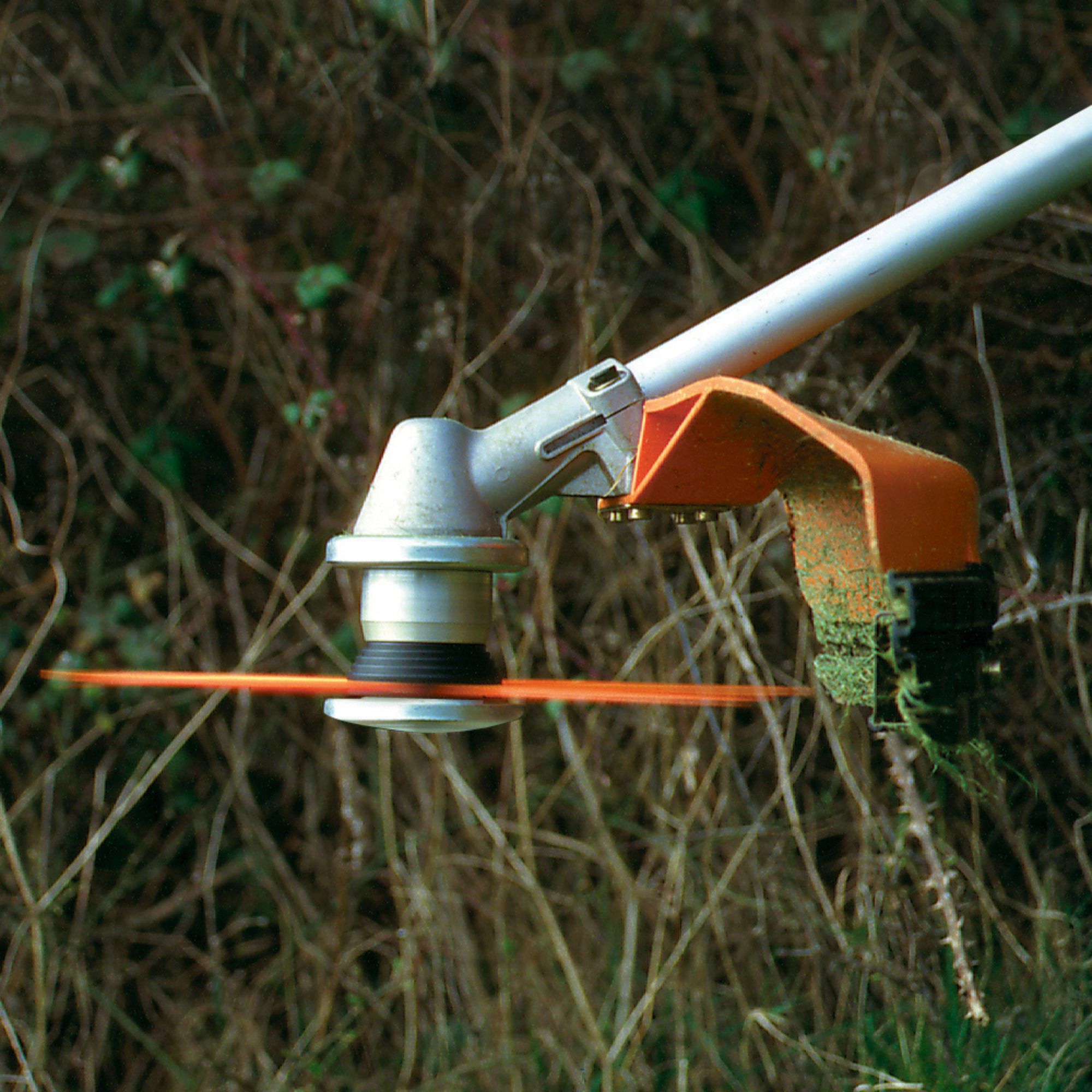 1cdz55pvgkv.jpg - Mowers Online String trimmer head with orange shield attachment