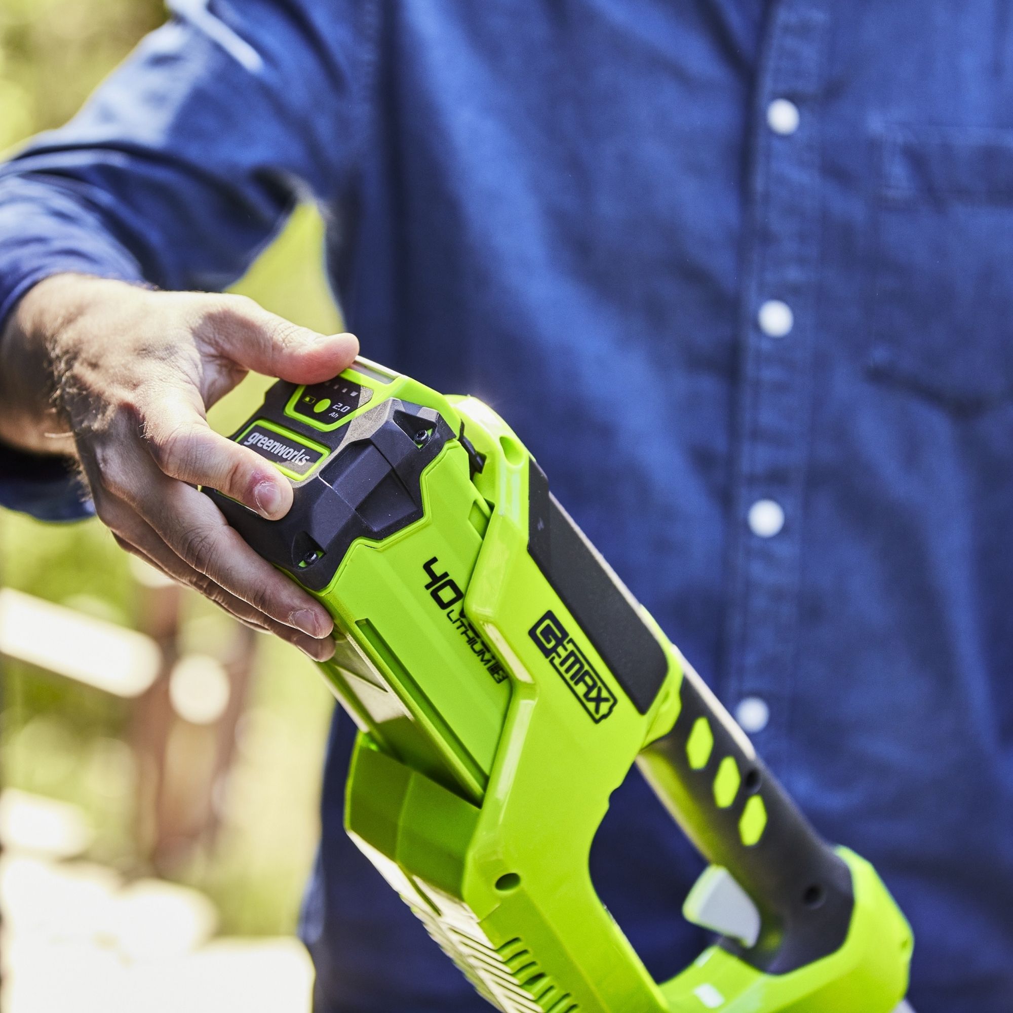1hma5z5dvfj.jpg - Mowers Online Person holding cordless power drill in high-visibility yellow