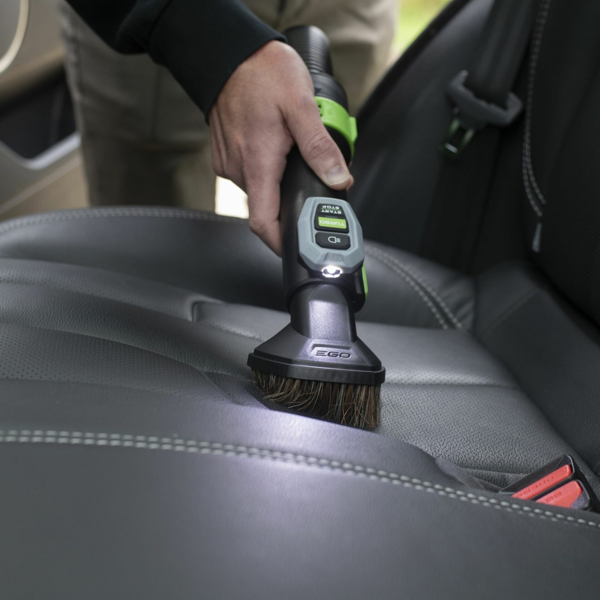 2kwgs4o3bj3.jpg - Mowers Online Person cleaning car seat with brush tool