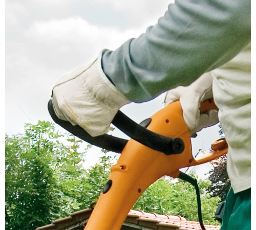 5aozg2vrmff.jpg - Mowers Online Person operating orange string trimmer