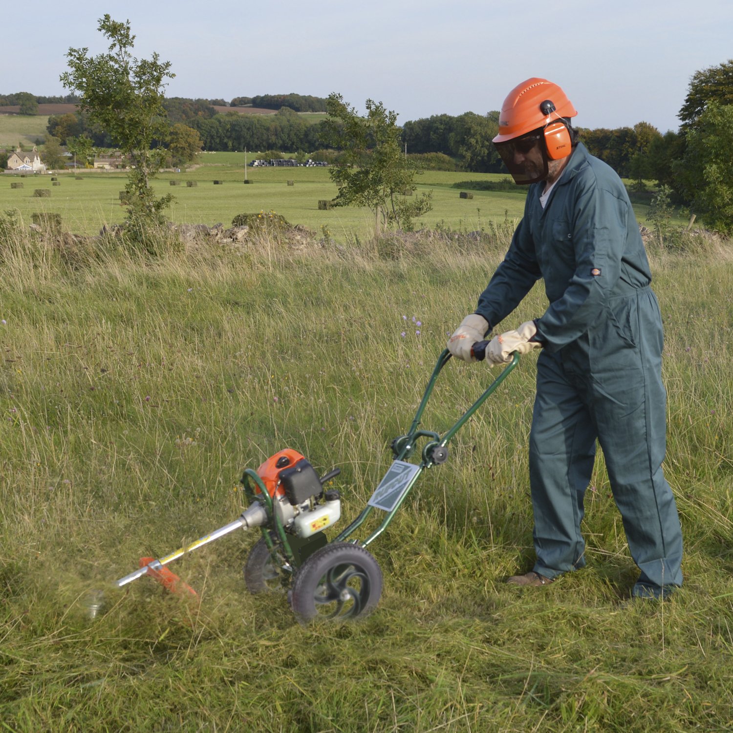 Rufcut-in-the-Field - Mowers Online Worker operating a Rufcut field mower in grass.