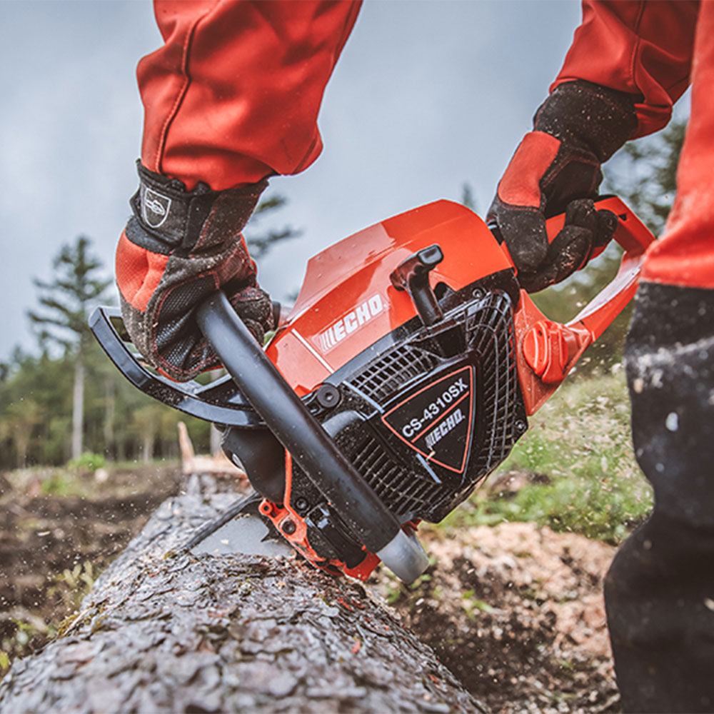 bc13tmc052w.jpg - Mowers Online Chainsaw being held by person in red clothing