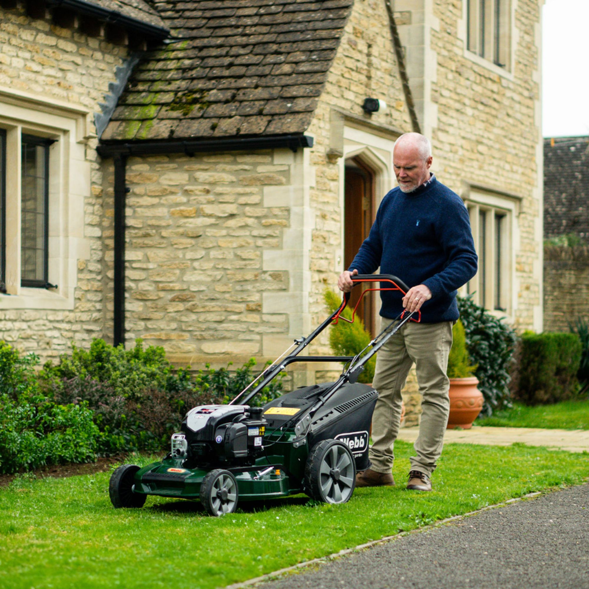 bxtwwpa3oky.jpg - Mowers Online Man operating self-propelled lawn mower on grass