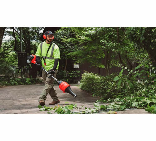 byb1ex5y0xw.jpg - Mowers Online Worker using string trimmer in wooded area