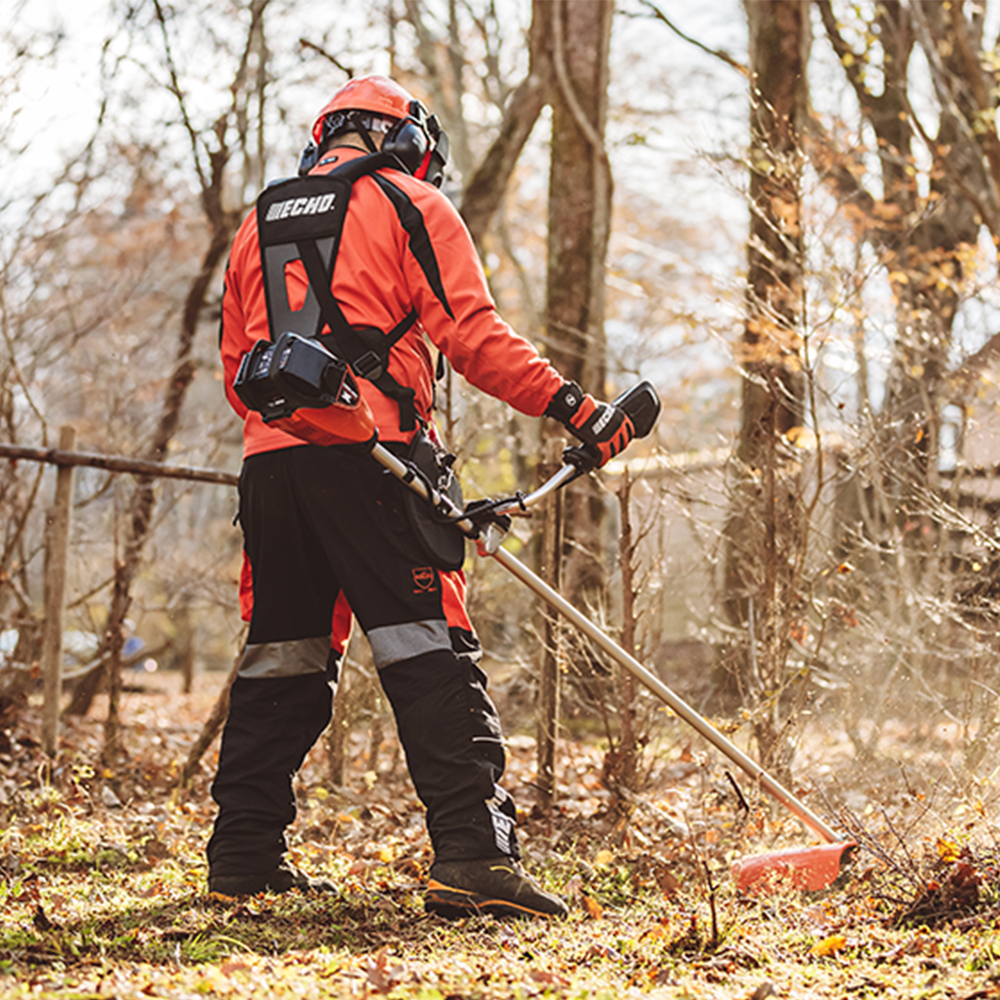 eps3wlgkudr.png - Mowers Online Person using string trimmer in wooded area