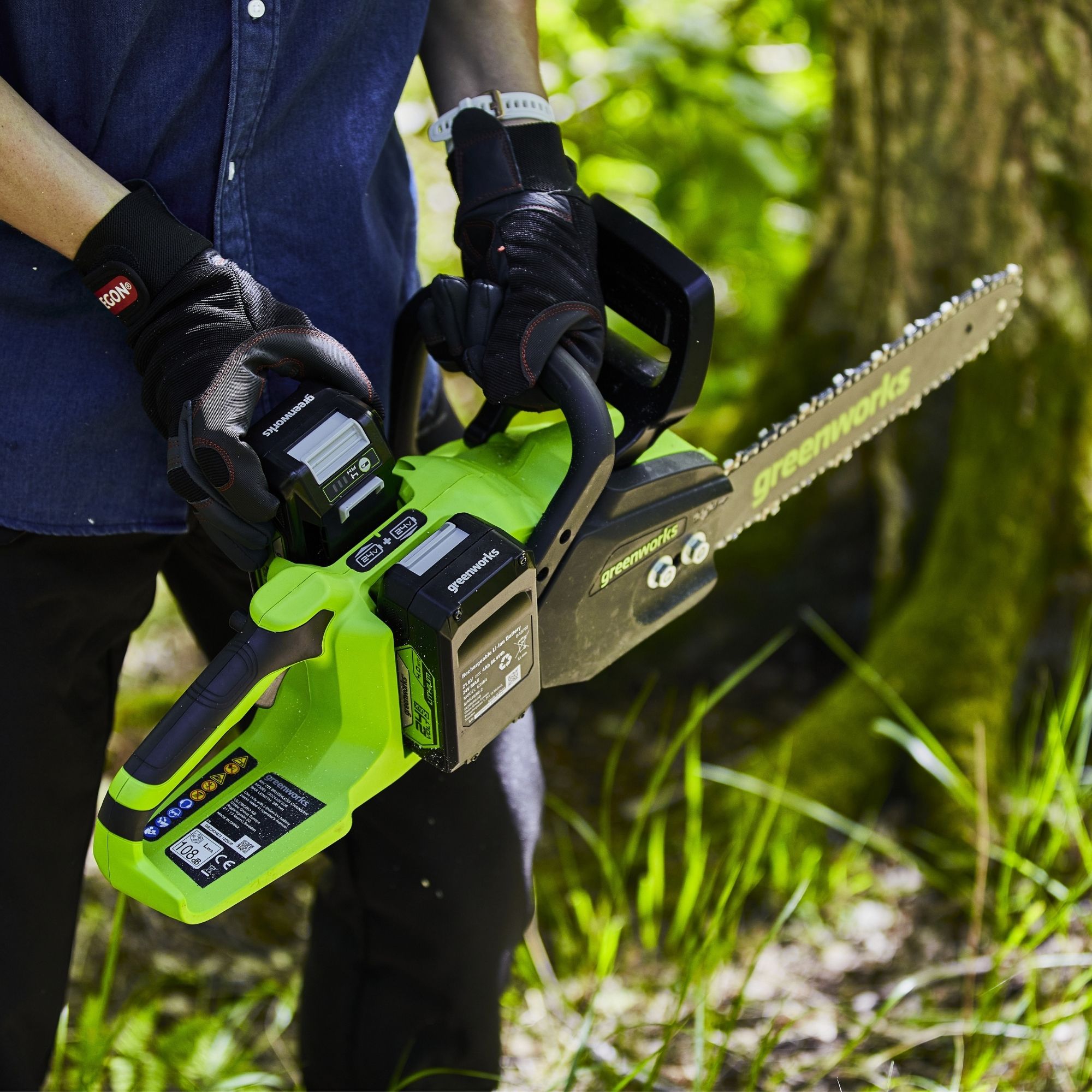 husjokrzfho.jpg - Mowers Online Person holding electric chainsaw in outdoor setting