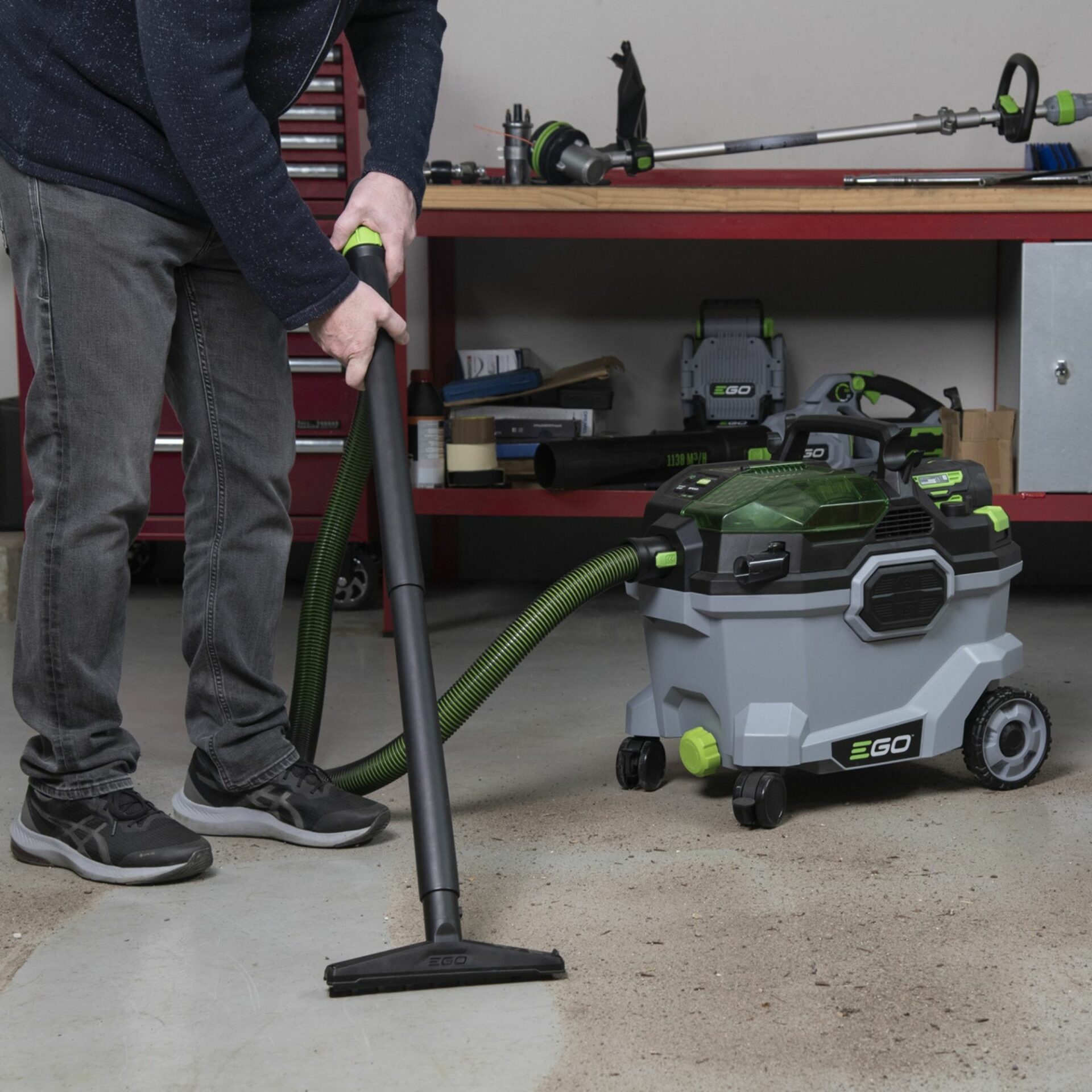 j2ba0znmt54.jpg - Mowers Online Person holding vacuum hose near workshop equipment