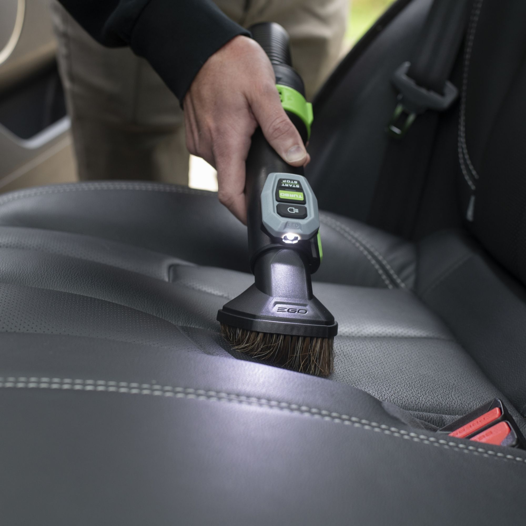 nitkwyjjjkr.jpg - Mowers Online Person cleaning car seat with brush tool