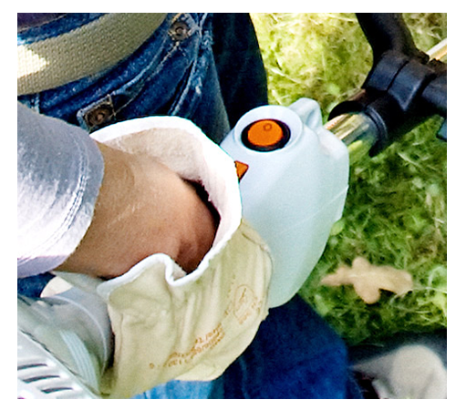 romthrf2xya.png - Mowers Online Person holding white handheld device with orange display