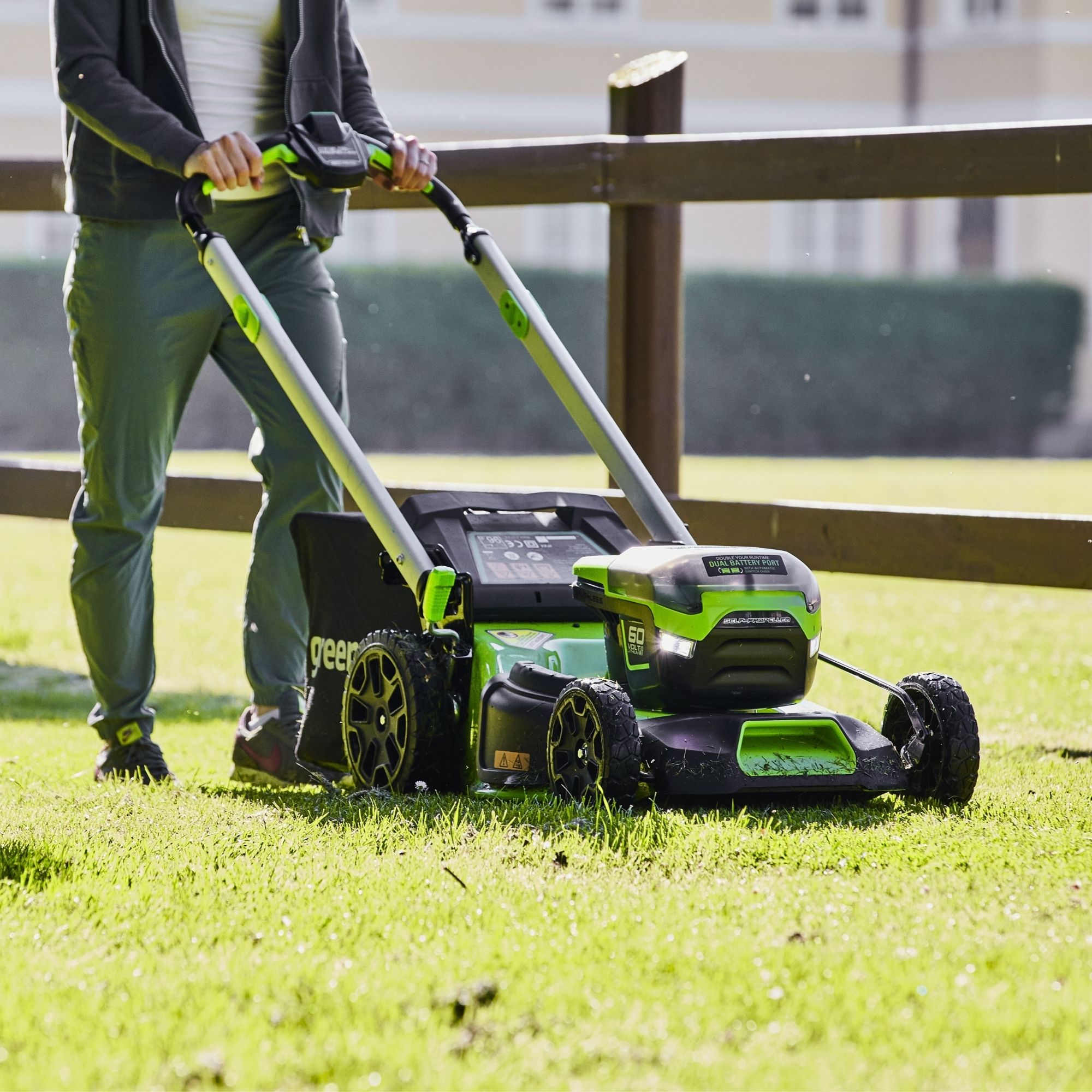 unnbtoyajoy.jpg - Mowers Online Person using green cordless push lawn mower