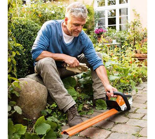 uzrvpz4jjrj.jpg - Mowers Online Older man using axe in garden
