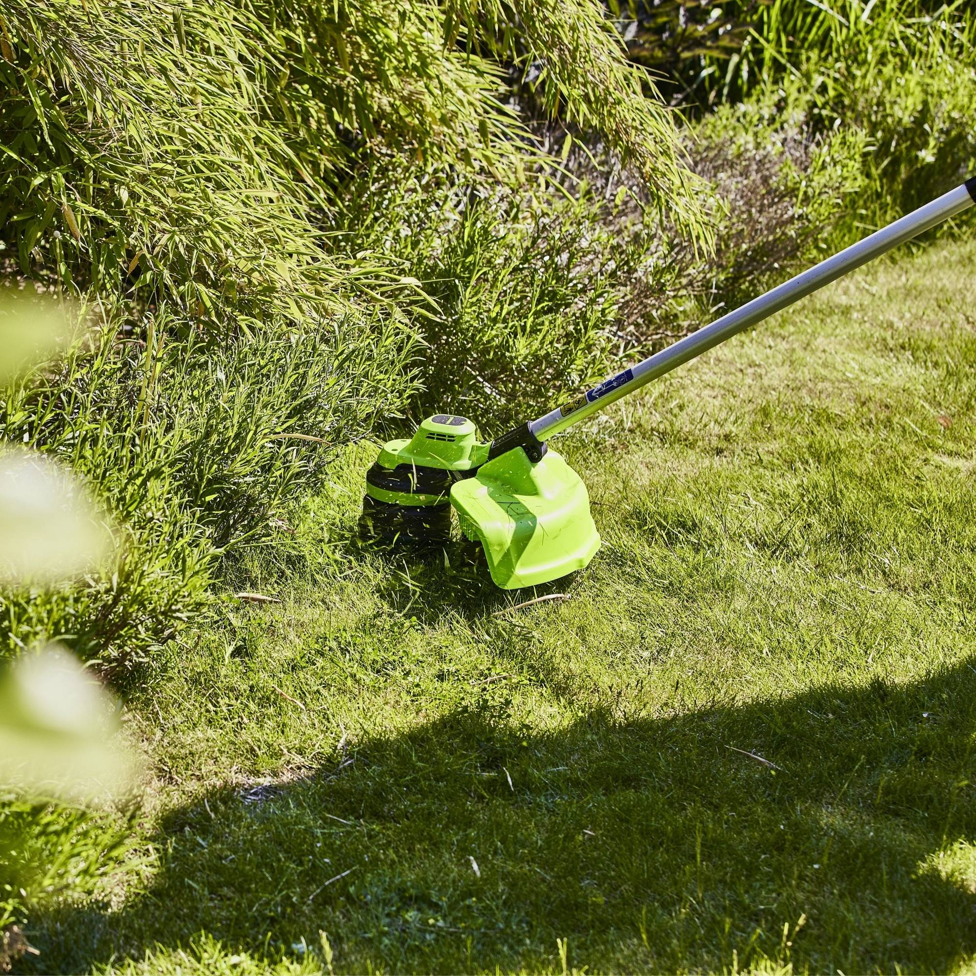 v2wvmsw3rpf.jpg - Mowers Online Cordless string trimmer on grass lawn