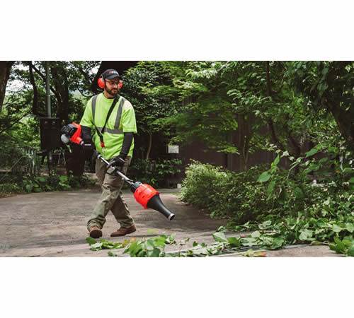 xkm5m3nks4c.jpg - Mowers Online Worker using leaf blower in wooded area