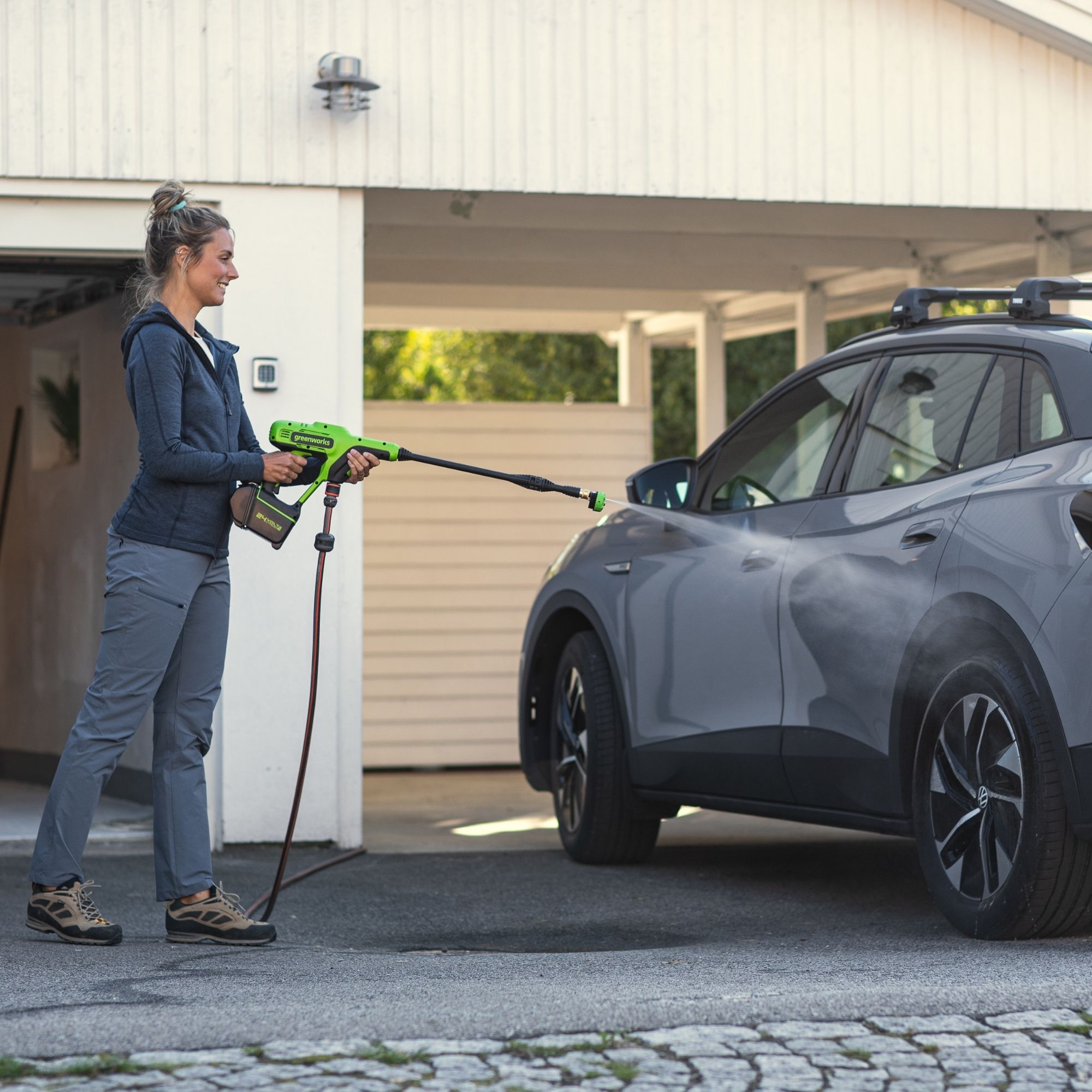 zeusmmmbaaz.jpg - Mowers Online Woman charging electric vehicle at home